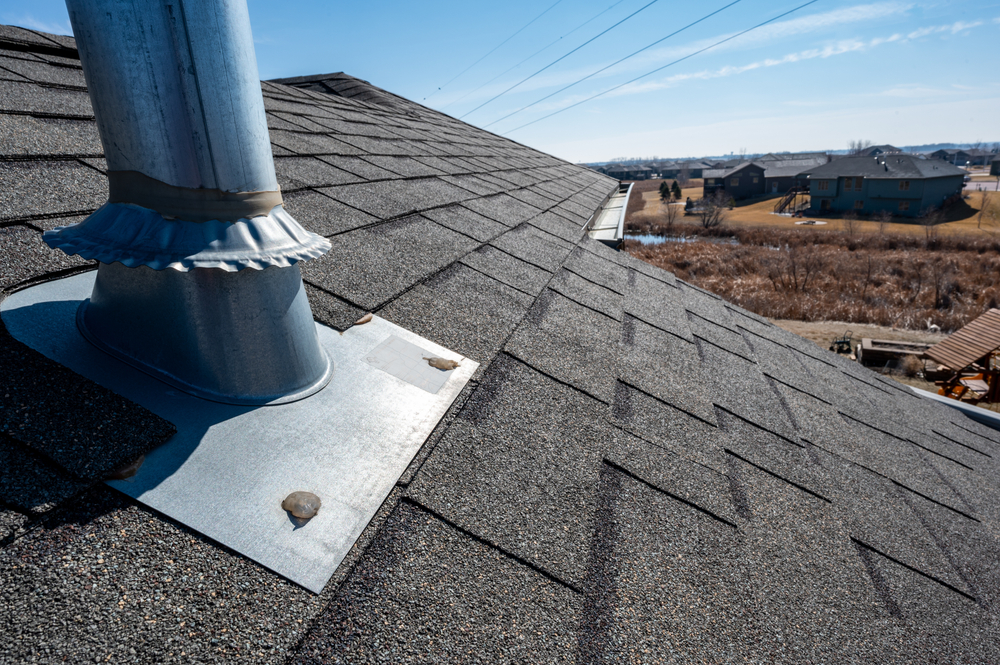 Vent,on,a,shingle,roof,with,silicon,caulking,and,flashing