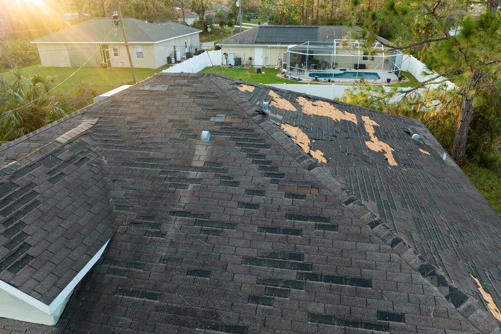 Consequences,of,natural,disaster.,damaged,house,roof,with,missing,shingles